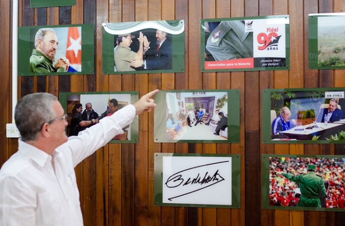 Julio César González Marchante points to pictures of former Cuban leader Fidel Castro on Thursday at the Cuban Embassy on High Street. The pictures were mounted as part of an exhibition to mark Cuban Cultural Day, which was observed on Thursday.